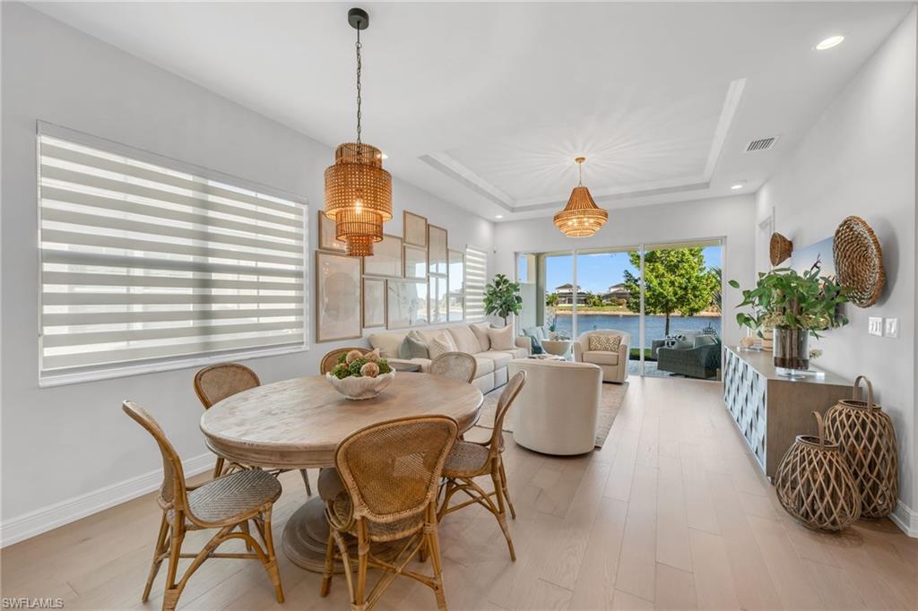 a dining room with furniture and wooden floor