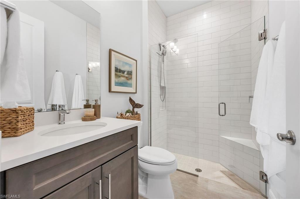 9028 Mayreau Way Naples, FL 34114 - Photo 15 of 24 a bathroom with a sink a toilet and shower