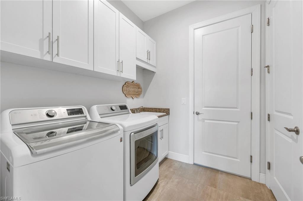 9028 Mayreau Way Naples, FL 34114 - Photo 16 of 24 a view of storage and utility room with washer and dryer