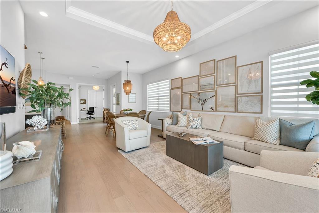 9028 Mayreau Way Naples, FL 34114 - Photo 3 of 24 a living room with fireplace furniture and a large window