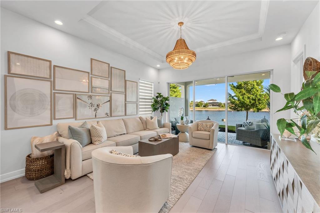 9028 Mayreau Way Naples, FL 34114 - Photo 5 of 24 a living room with furniture kitchen view and a large window
