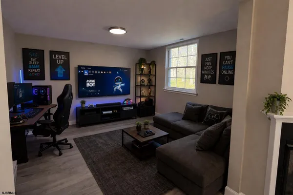 a living room with furniture gym equipment and a window