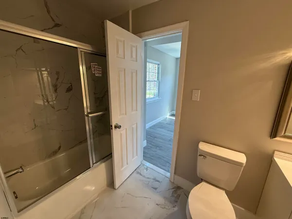 a bathroom with a toilet and a shower