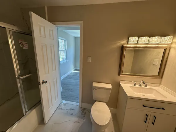 a bathroom with a toilet sink and shower