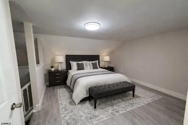 a bedroom with a bed and a mirror