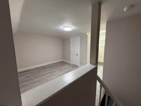 a view of storage and utility room with wooden floor