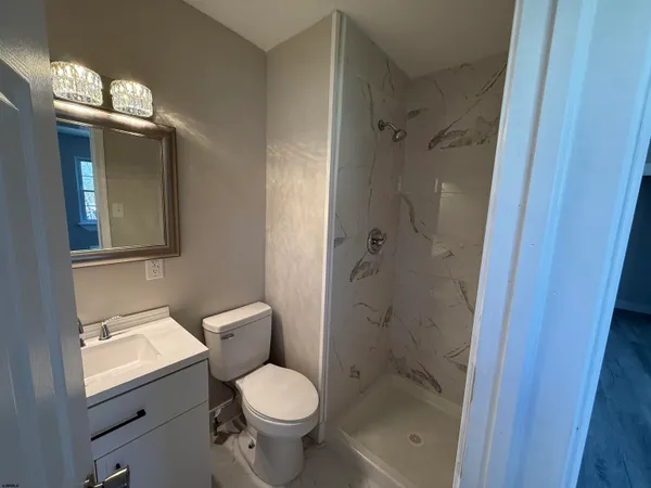 a bathroom with a toilet sink and shower