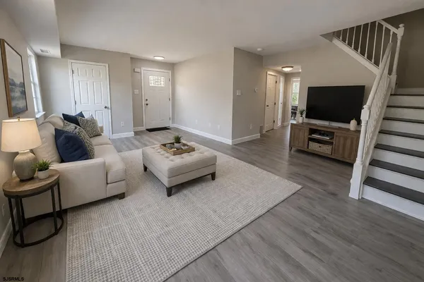 a living room with furniture and a flat screen tv