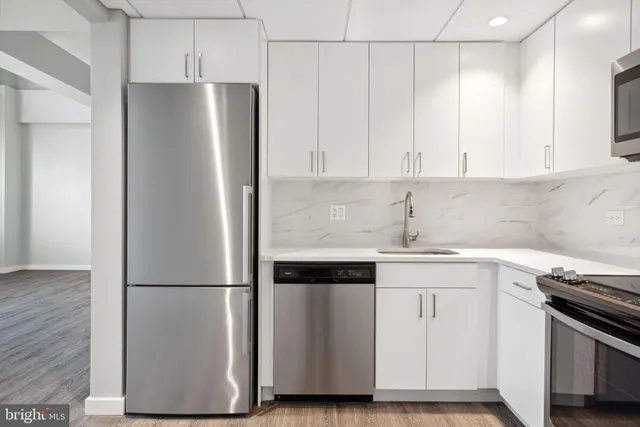 a kitchen with cabinets and stainless steel appliances