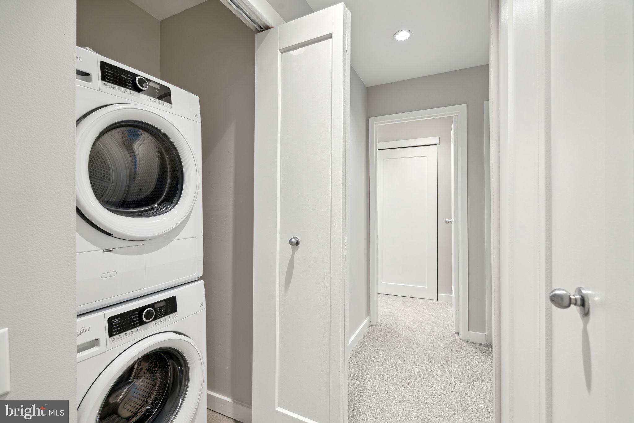 101-111 South 9th Street, Unit PH107 Philadelphia, PA 19107 - Photo 32 of 42 a view of a hallway with washer and dryer