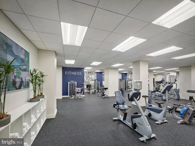 a living room with lots of furniture and chandelier