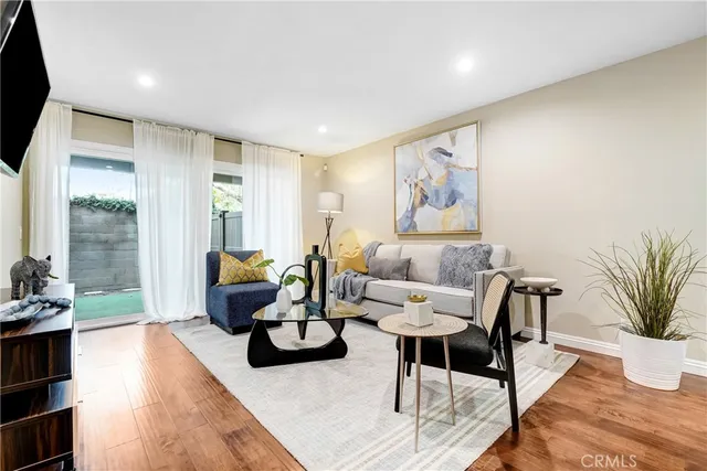 a living room with furniture and wooden floor