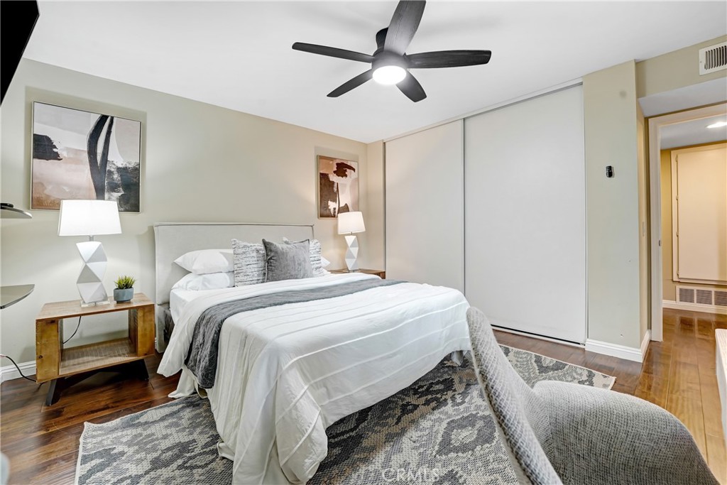 6882 Alondra Boulevard, Unit 26 Paramount, CA 90723 - Photo 12 of 14 a bedroom with a bed and a lamp