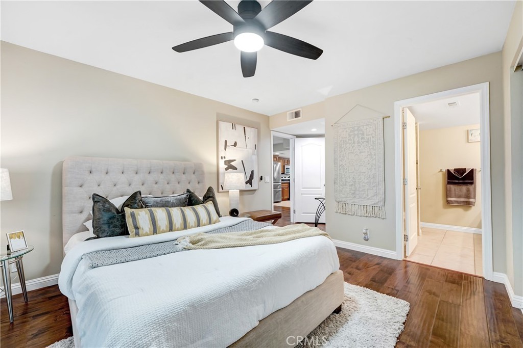 6882 Alondra Boulevard, Unit 26 Paramount, CA 90723 - Photo 7 of 14 a bedroom with a large bed and a chandelier