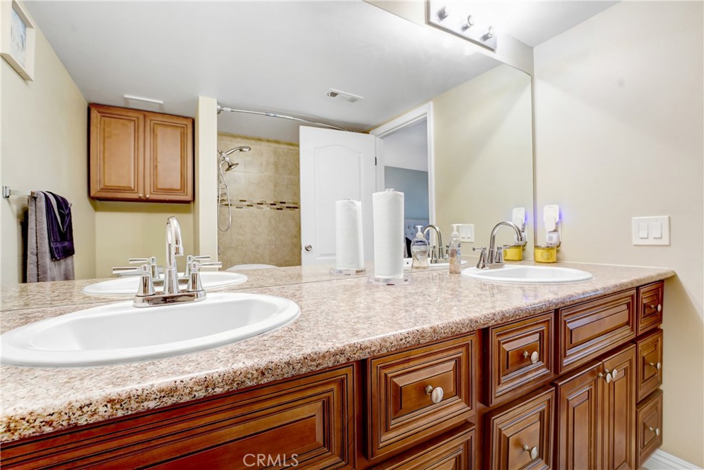 6882 Alondra Boulevard, Unit 26 Paramount, CA 90723 - Photo 8 of 14 a bathroom with granite countertop double vanity and a mirror