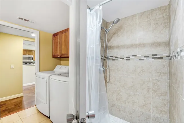 a bathroom with a sink a mirror and shower