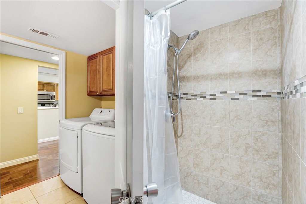 6882 Alondra Boulevard, Unit 26 Paramount, CA 90723 - Photo 9 of 14 a bathroom with a sink a mirror and shower