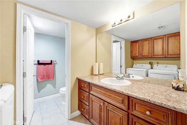 a bathroom with a granite countertop sink a mirror and a bathtub