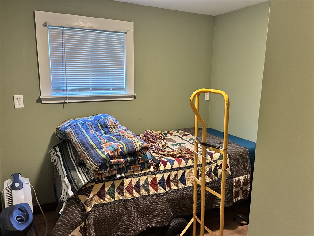 559 Tea Street, Unit 1 Charlemont, MA 01339 - Photo 12 of 14 a bedroom with a bed and dresser