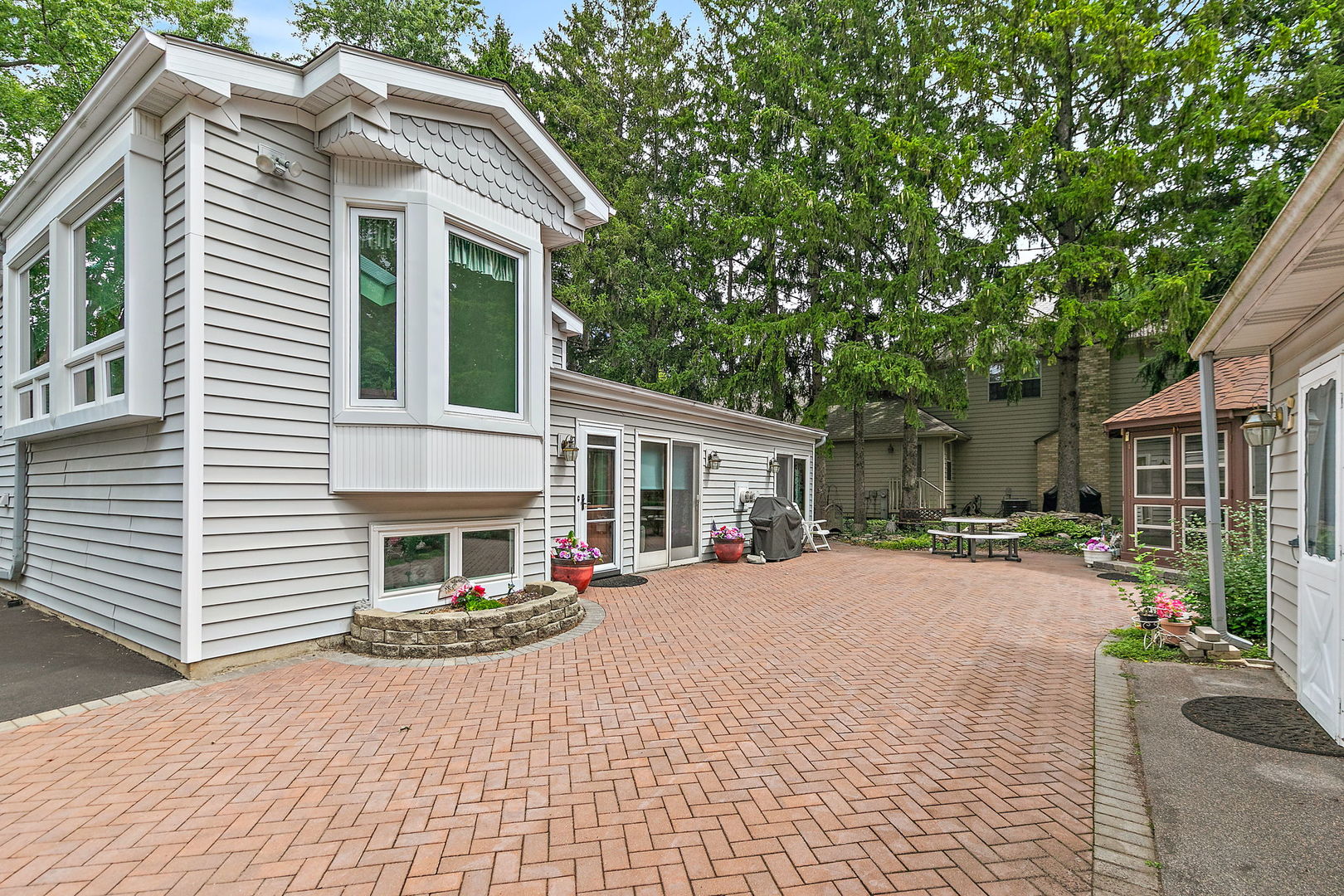 1151 Country Club Road Lake Zurich, IL 60047 - Photo 54 of 58 a front view of a house with a yard and potted plants