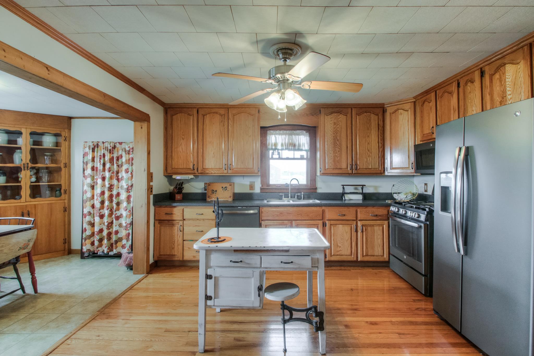 598 White Road Portland, TN 37148 - Photo 8 of 19 a kitchen with stainless steel appliances kitchen island granite countertop a refrigerator a stove a sink a dining table and chairs with wooden floor