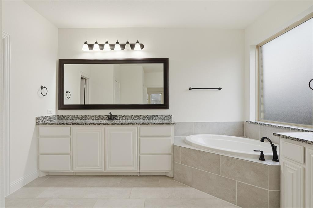 2604 Dylan Lane Mansfield, TX 76063 - Photo 14 of 33 a bathroom with a tub sink and mirror