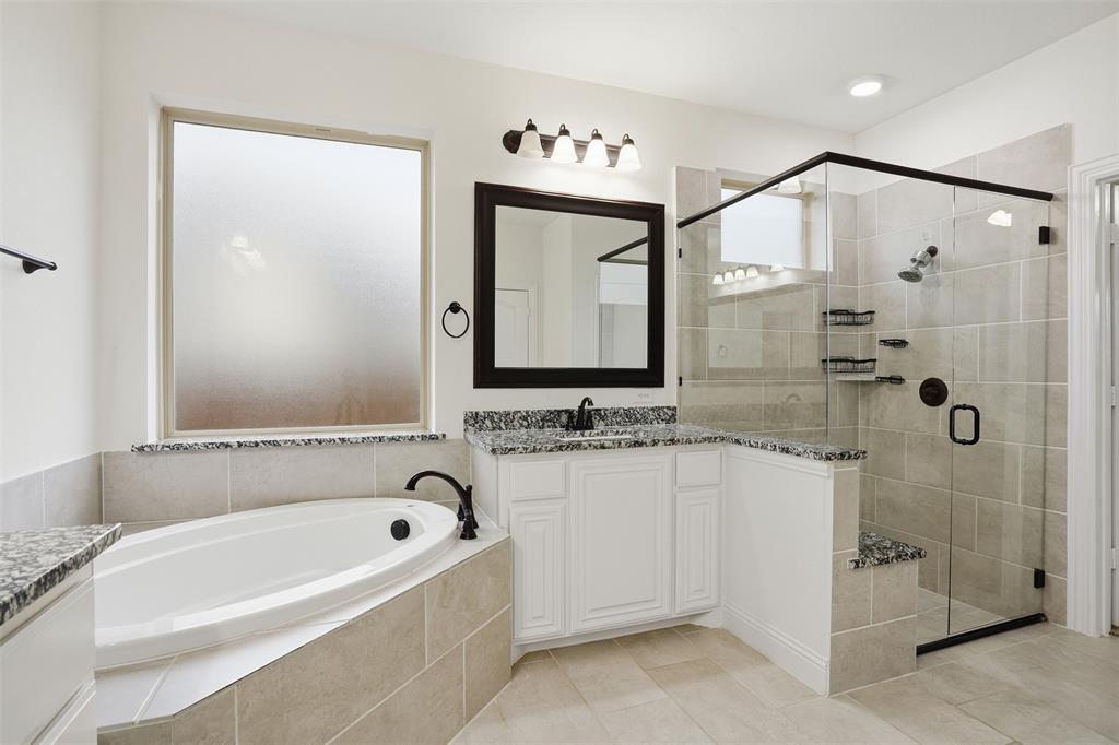 2604 Dylan Lane Mansfield, TX 76063 - Photo 15 of 33 a bathroom with a bathtub a sink and a shower