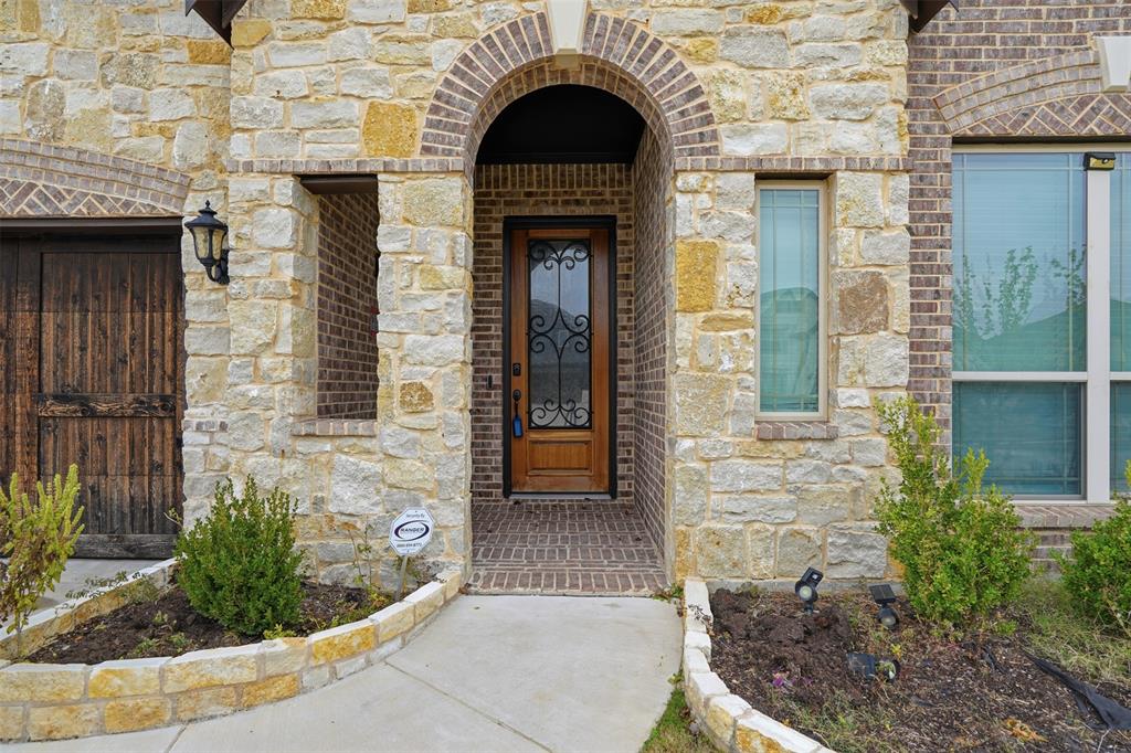 2604 Dylan Lane Mansfield, TX 76063 - Photo 2 of 33 a view of a brick house with potted plants