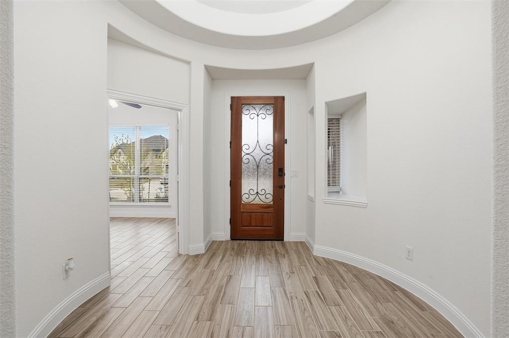 2604 Dylan Lane Mansfield, TX 76063 - Photo 4 of 33 an empty room with wooden floor and windows