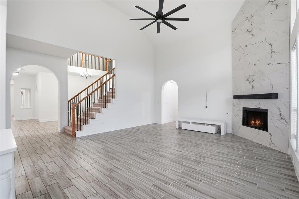 2604 Dylan Lane Mansfield, TX 76063 - Photo 8 of 33 a view of a livingroom with wooden floor and a fireplace