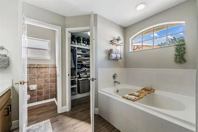 a bathroom with bathtub and window
