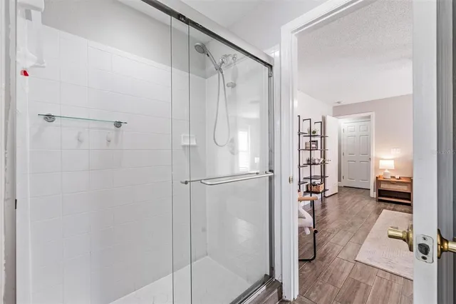 a bathroom with a glass shower door