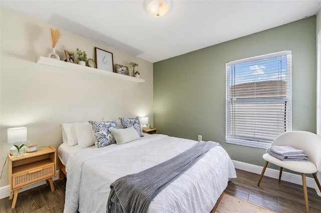 a bedroom with a bed and a chair