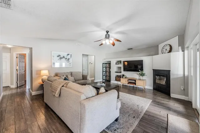a living room with furniture fireplace and a flat screen tv