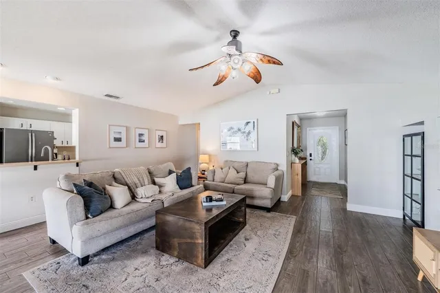 a living room with furniture and wooden floor