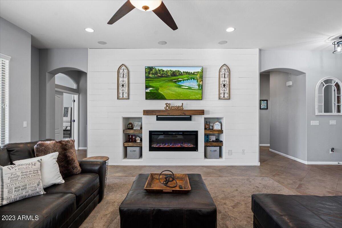 6730 Rachael Way Gilbert, AZ 85298 - Photo 16 of 77 a living room with furniture and a fireplace