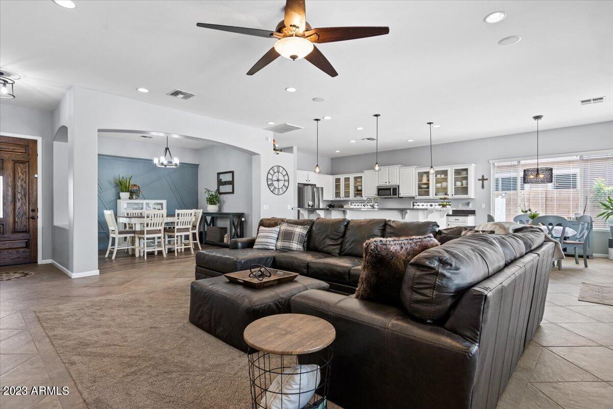 6730 Rachael Way Gilbert, AZ 85298 - Photo 17 of 77 a living room with furniture kitchen view and a chandelier