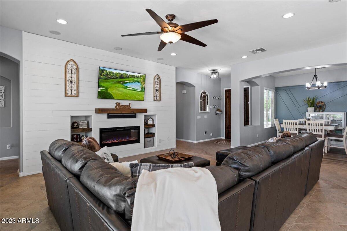 6730 Rachael Way Gilbert, AZ 85298 - Photo 18 of 77 a living room with furniture a fireplace and a flat screen tv
