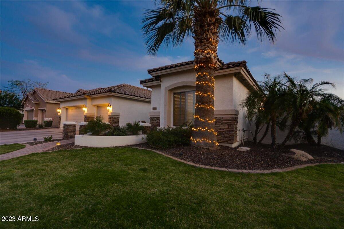 6730 Rachael Way Gilbert, AZ 85298 - Photo 3 of 77 a front view of a house with a garden and yard