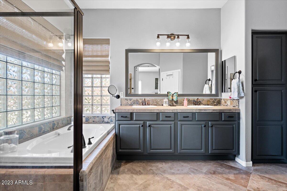 6730 Rachael Way Gilbert, AZ 85298 - Photo 32 of 77 a spacious bathroom with a sink double vanity and a mirror