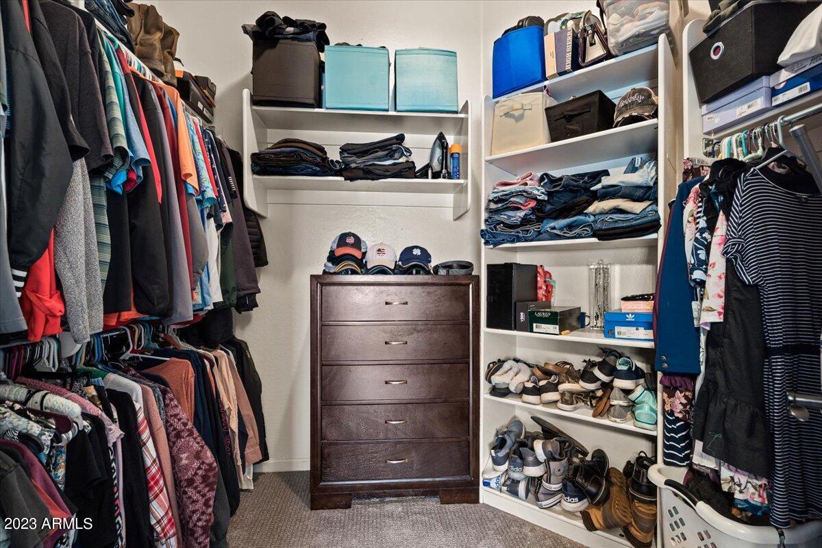6730 Rachael Way Gilbert, AZ 85298 - Photo 34 of 77 a view of walk in closet with clothes and shoes