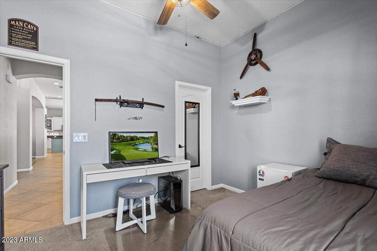 6730 Rachael Way Gilbert, AZ 85298 - Photo 38 of 77 a bedroom with a bed and a chandelier