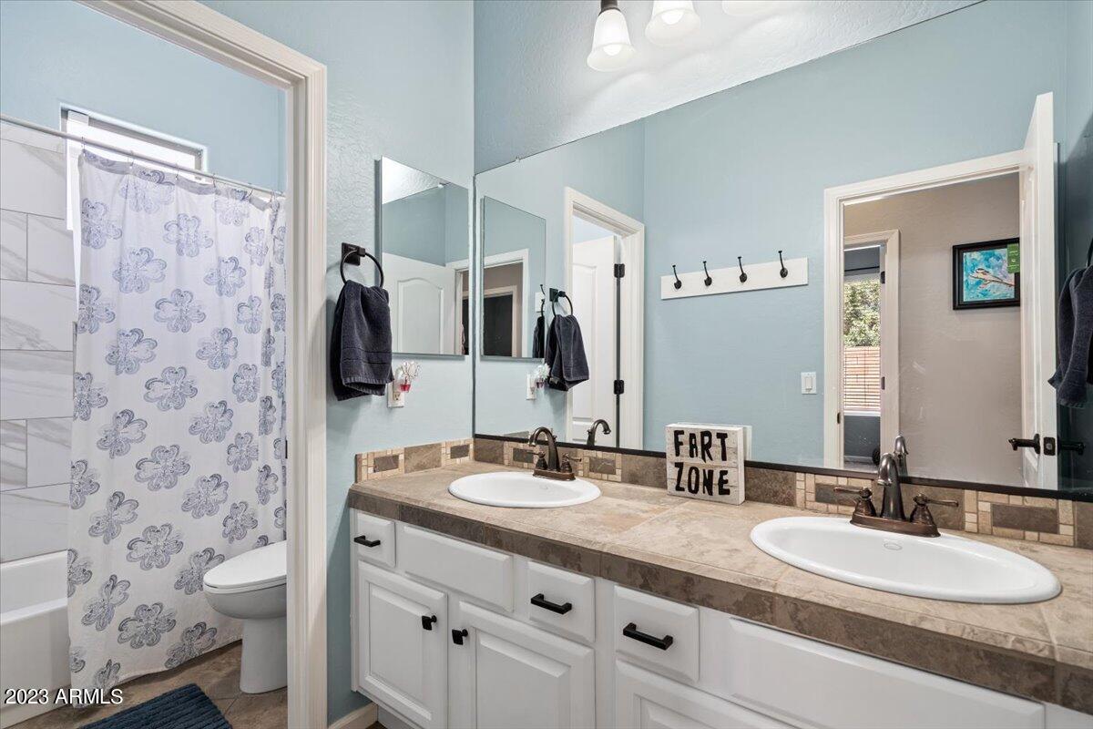 6730 Rachael Way Gilbert, AZ 85298 - Photo 41 of 77 a bathroom with a double vanity sink mirror and shower