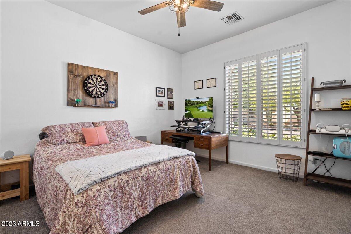 6730 Rachael Way Gilbert, AZ 85298 - Photo 42 of 77 a bedroom with a bed and a table in it