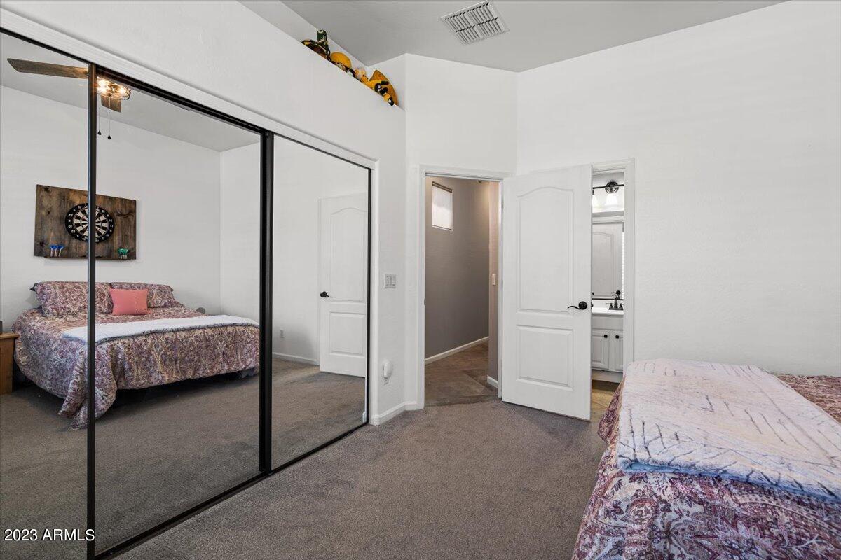 6730 Rachael Way Gilbert, AZ 85298 - Photo 43 of 77 a bedroom with a bed and a lamp