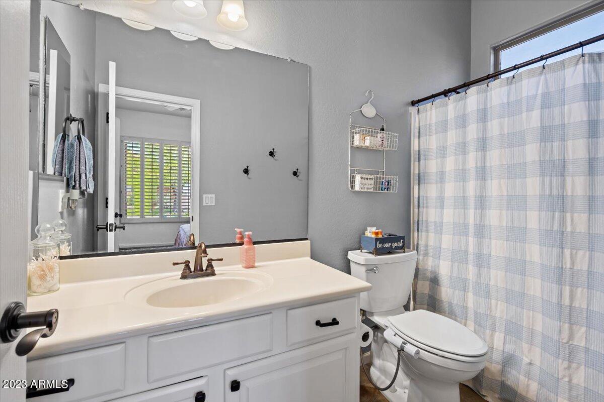 6730 Rachael Way Gilbert, AZ 85298 - Photo 44 of 77 a bathroom with a sink a toilet and shower curtain