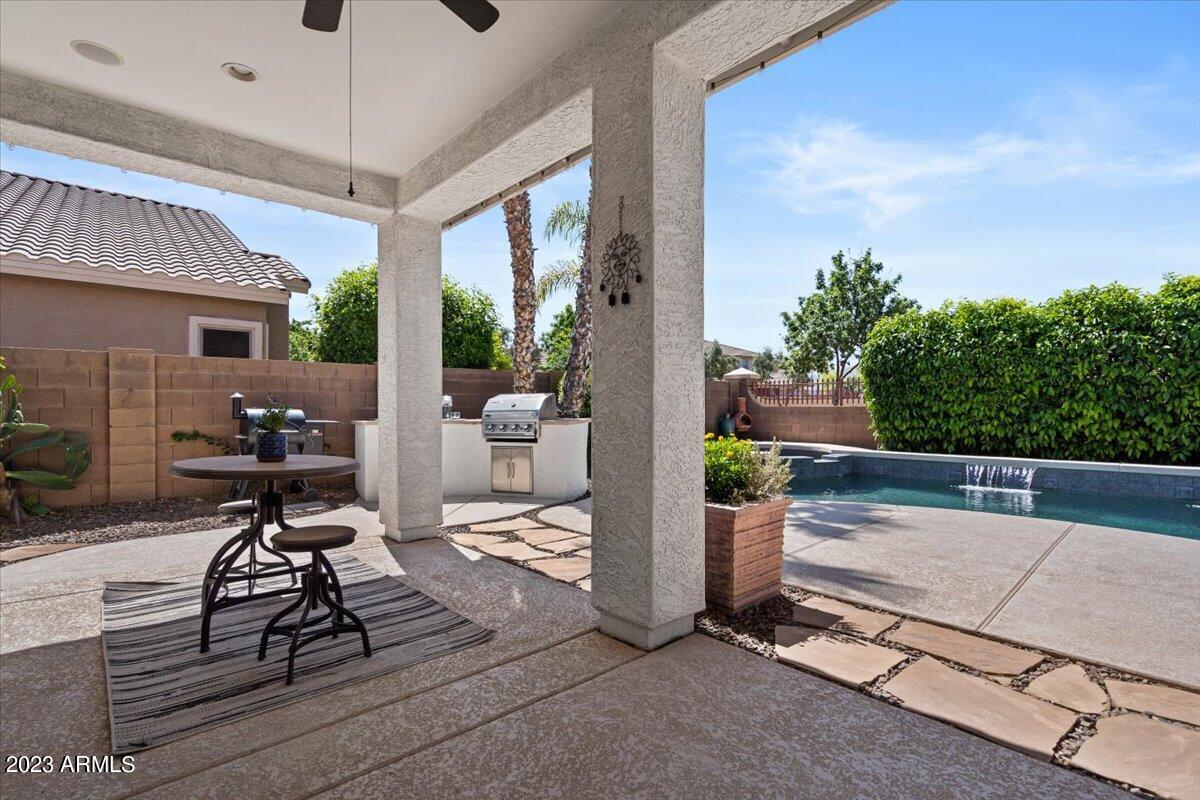 6730 Rachael Way Gilbert, AZ 85298 - Photo 48 of 77 a view of a patio with table and chairs potted plants with wooden floor
