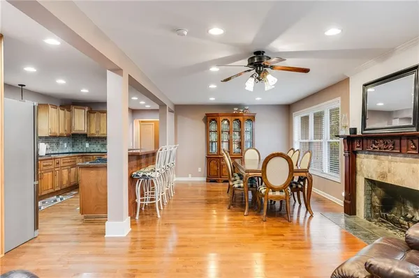 a view of a a dining room with furniture window and wooden floor
