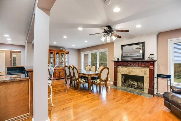 a view of a livingroom with furniture a fireplace a rug and a chandelier