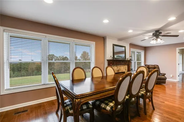 a dining room with furniture and wooden floor